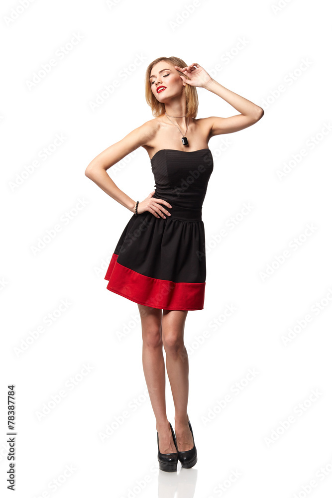 Confident smiling elegant woman in dress standing in full length Confident smiling elegant woman in dress standing in full length