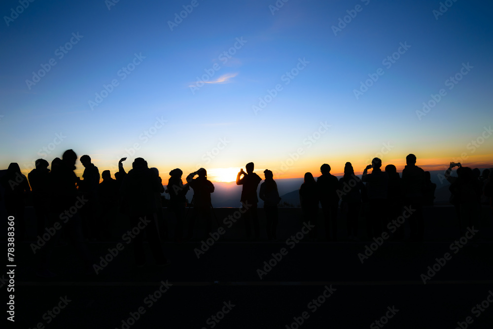 Silhouette of people and tourist during a beautiful mountain su