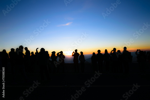 Silhouette of people and tourist during a beautiful mountain su