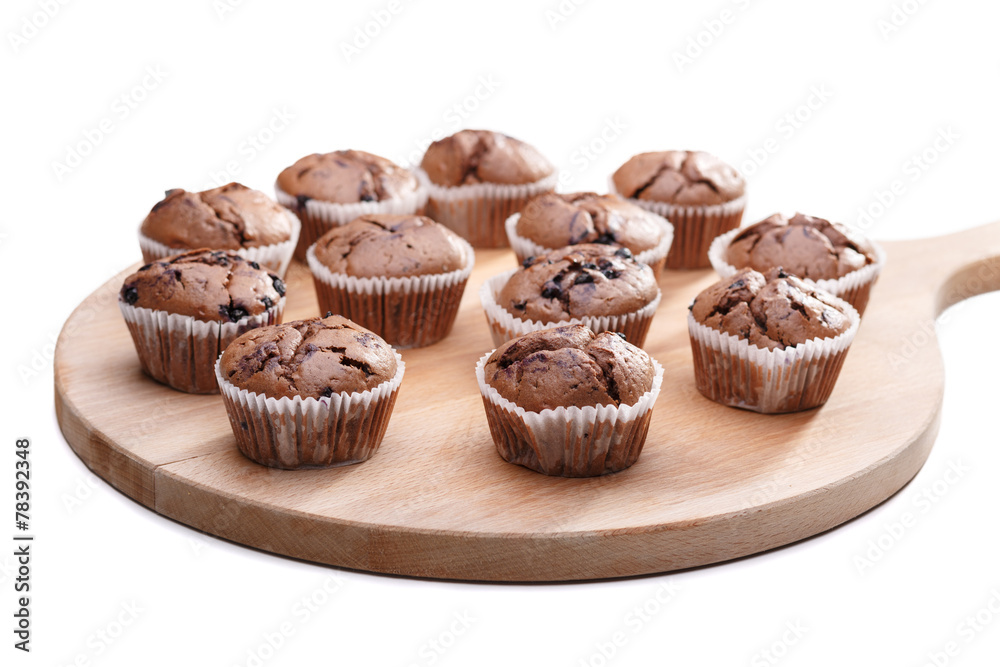 Delicious chocolate muffins on wooden board Delicious chocolate muffins on wooden board