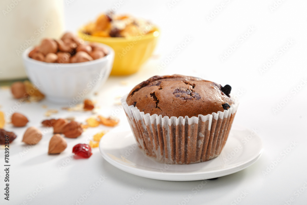 Delicious chocolate muffins on wooden board 