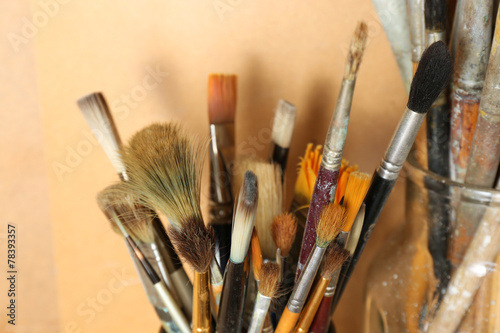 Different paintbrushes on wooden background