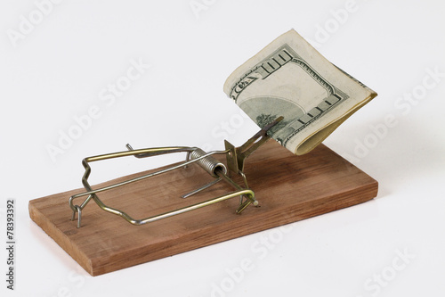 mousetrap with money on a white background