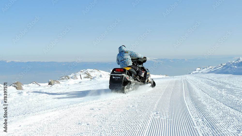 Single Man On A Snowmobile