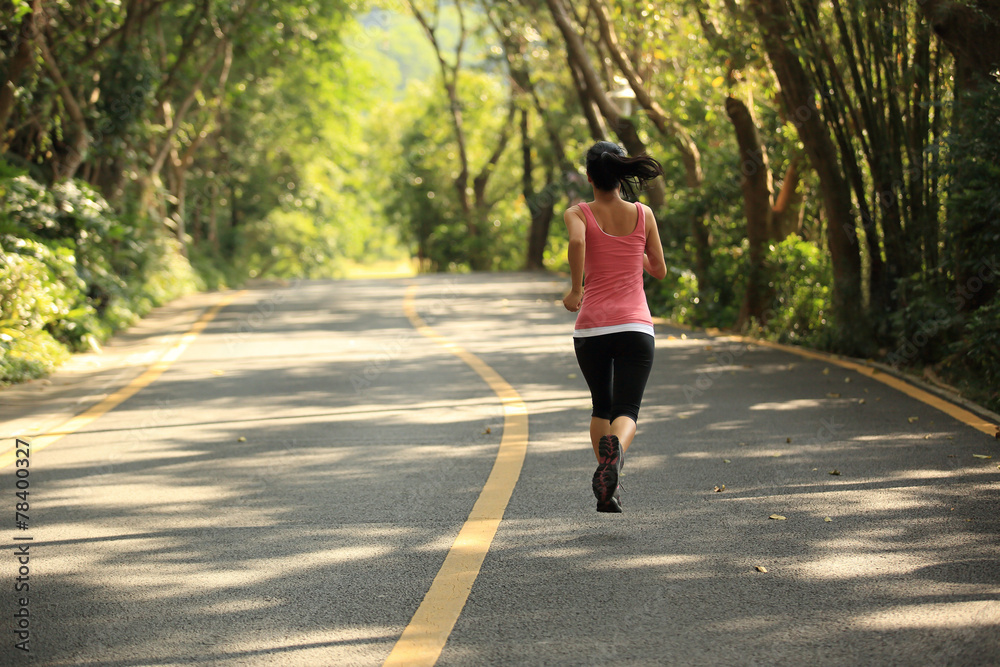 woman runner athlete running at forest rail woman runner athlete running at forest rail