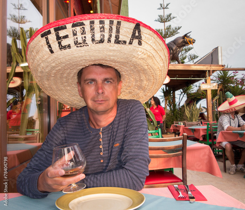 Drinker man in Mexican sambrero