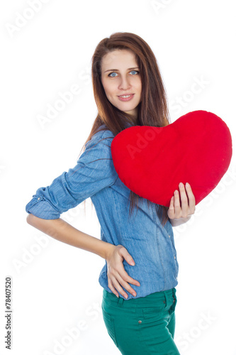 Brunette holding a red heart in hands on white background