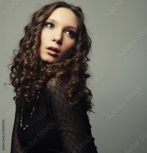 Young fashion model with curly hair