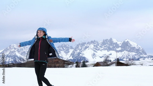 Young beautiful woman rotates in winter scenery, slow motion