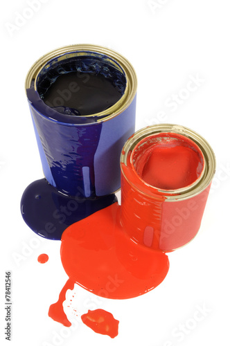 Messy red and blue paint tins or cans with spilled paint photo