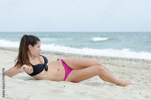 Sexy athletic women in bikini, ocean as background