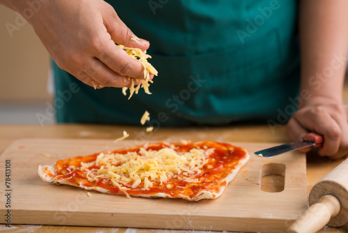 Sprinkling grated cheese photo