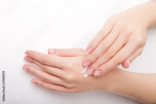 Beautiful young woman hands with cream.