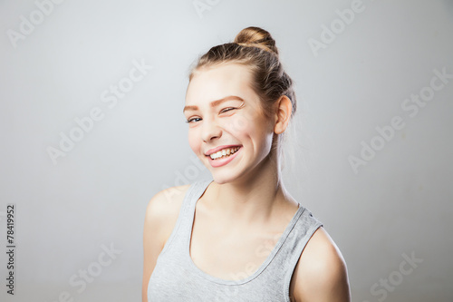 Closeup of a beautiful young woman winking.