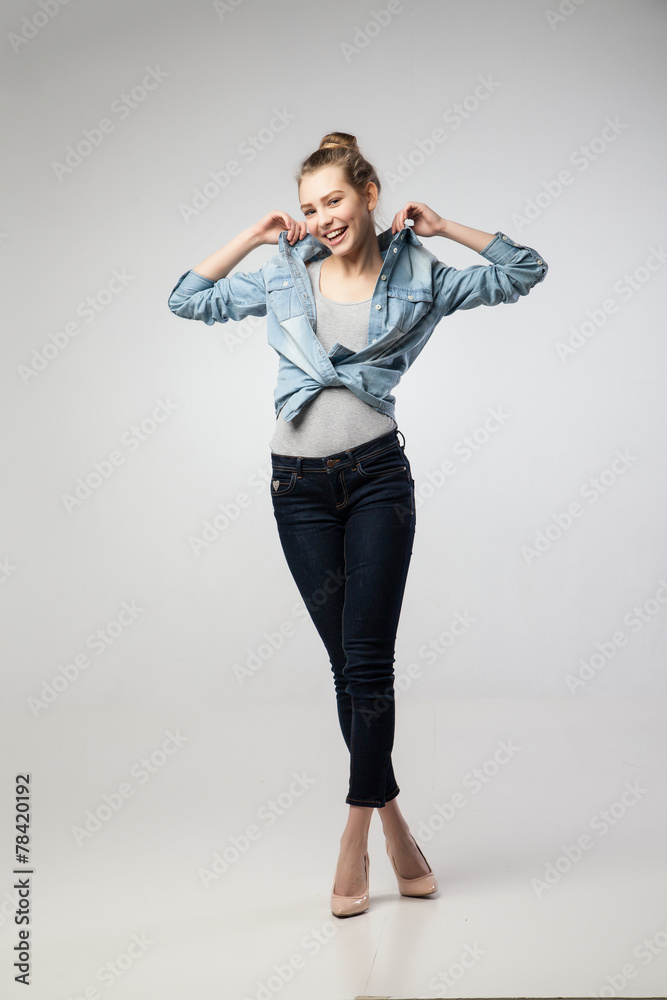 Beautiful happy woman raising collar of her shirt Beautiful happy woman raising collar of her shirt