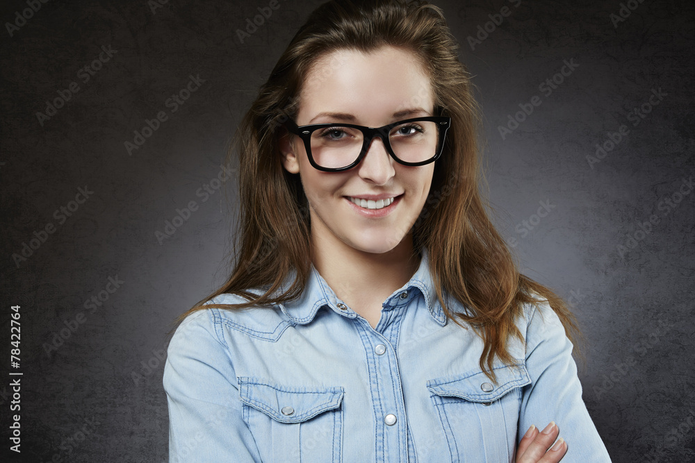 Fototapeta premium Smiling cute teenager in nerdy glasses