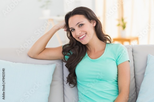 Pretty brunette sitting on the couch