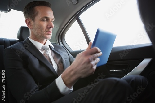 Handsome businessman using his tablet pc © WavebreakmediaMicro