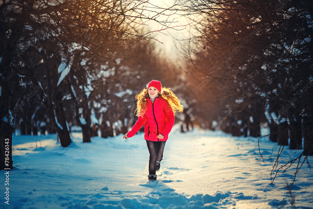 Beauty Teenager Girl Running in frosty winter Park. Outdoors. Su