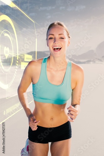 Composite image of fit woman smiling and jogging on the beach