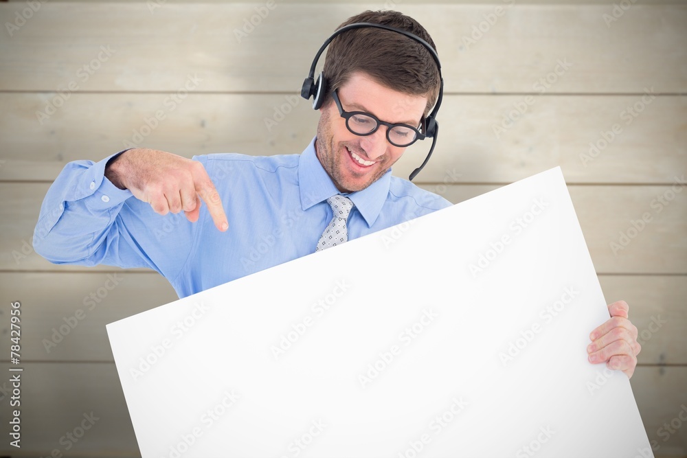 Composite image of businessman showing card wearing headset Composite image of businessman showing card wearing headset
