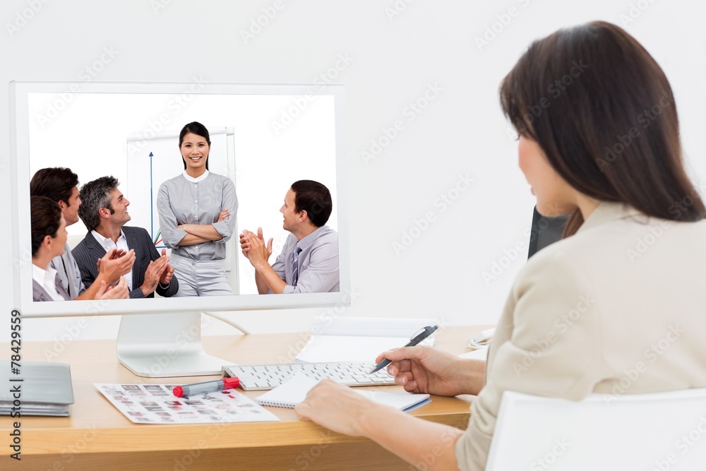 Composite image of portrait of a business team sitting together Composite image of portrait of a business team sitting together