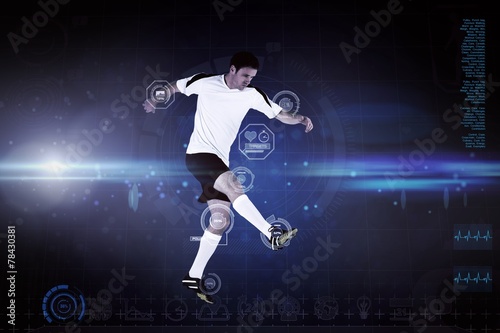 Composite image of football player in white kicking © WavebreakmediaMicro