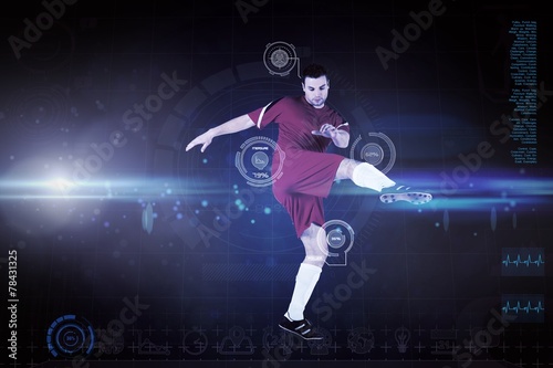 Composite image of football player in red kicking © WavebreakMediaMicro