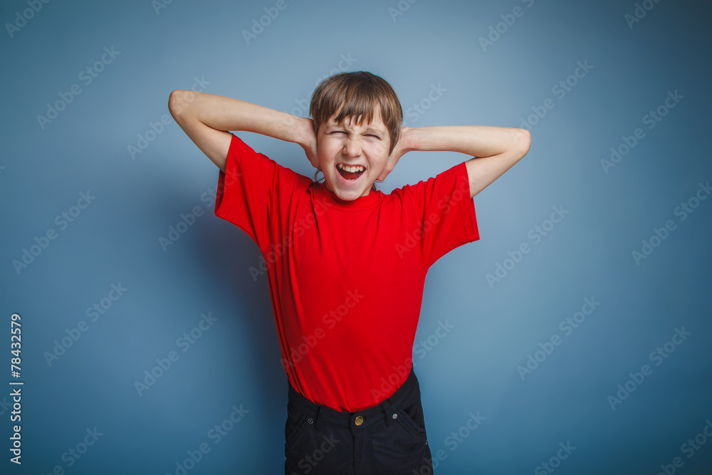 boy teenager European appearance in a red shirt covered his ears boy teenager European appearance in a red shirt covered his ears