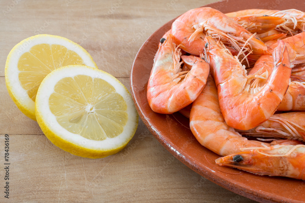 boiled shrimp with lemon arranged on kitchen board boiled shrimp with lemon arranged on kitchen board