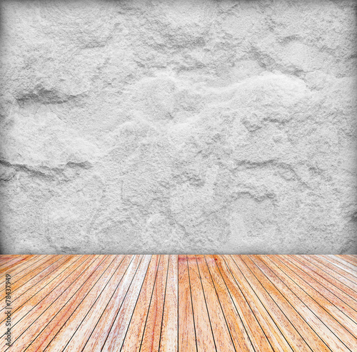 Backdrop sandstone wall and wood slabs arranged in perspective.