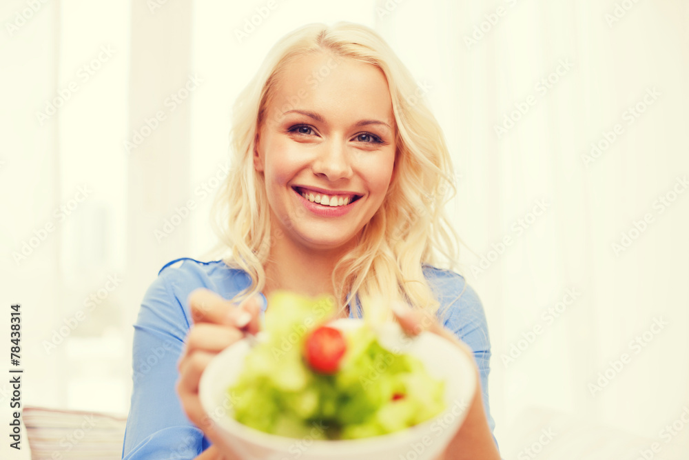 smiling young woman with green salad at home smiling young woman with green salad at home