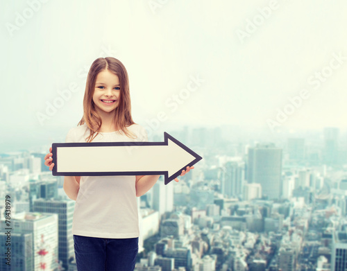 smiling girl with blank arrow pointing right