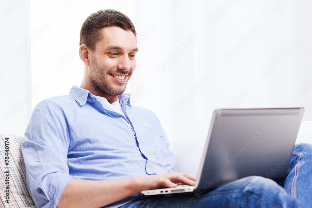 smiling man working with laptop at home smiling man working with laptop at home