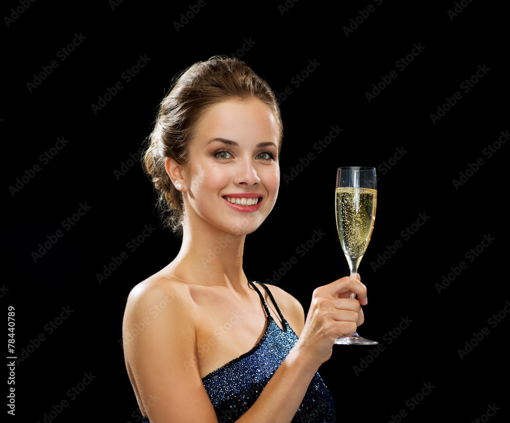 smiling woman holding glass of sparkling wine smiling woman holding glass of sparkling wine