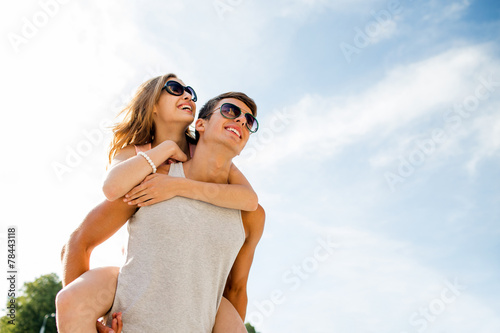 smiling couple having fun over sky background © Syda Productions