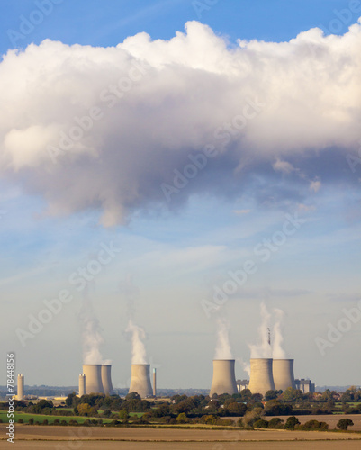 Cooling towers spew clouds into the atmosphere photo