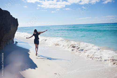 A young woman runs along the seacoast