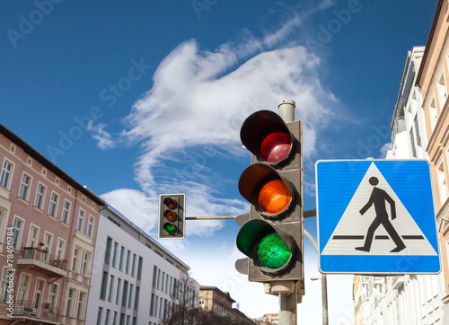 Traffic lights and pedestrian crossing sign in a city, Szczecin, Poland.