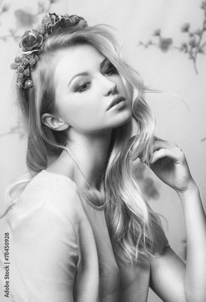 Naklejka premium Portrait of romantic tender blond girl with flowers in her hair