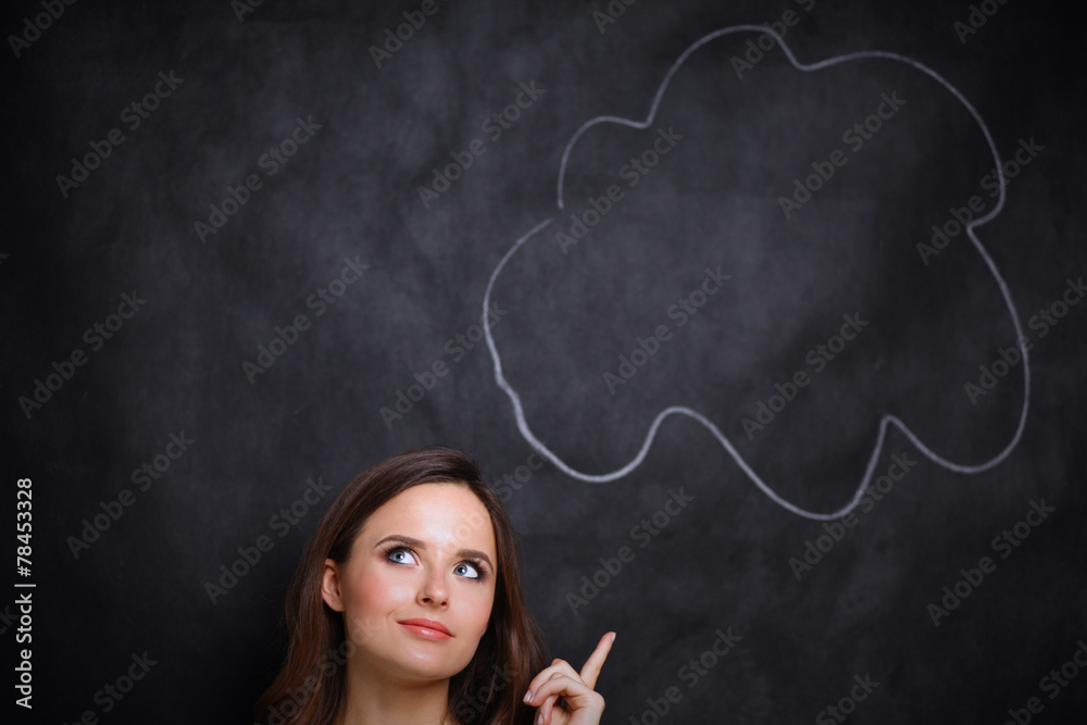 portrait of attractive girl thinking and pointing up to blank portrait of attractive girl thinking and pointing up to blank