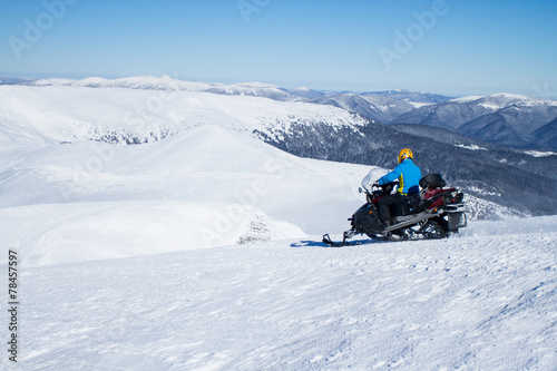 Man on snowmobile in winter mountain © vetal1983