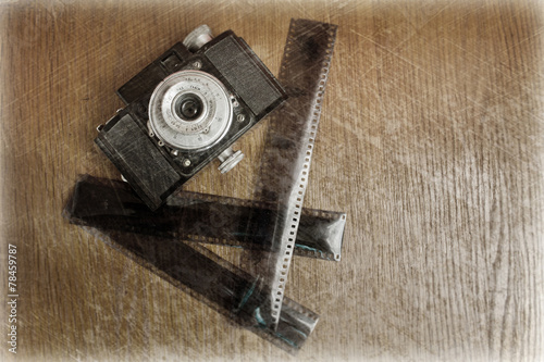 photo of an old camera and film, processed in retro style