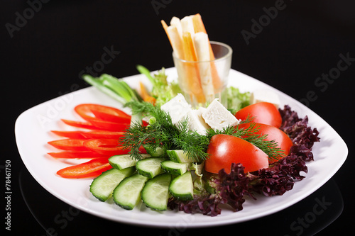 Fresh vegetable salad on a black background
