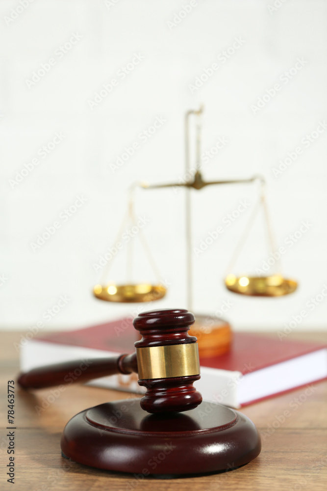 Wooden judges gavel on wooden table, close up Wooden judges gavel on wooden table, close up