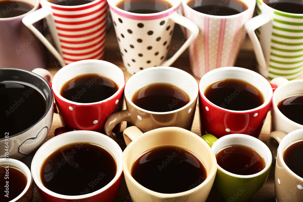 Many cups of coffee on wooden table background, closeup view Many cups of coffee on wooden table background, closeup view
