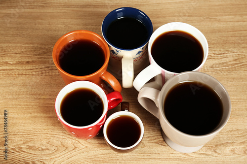 Many cups of coffee on wooden table background, closeup view