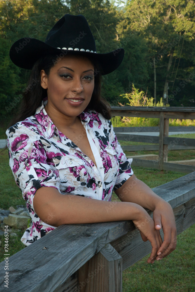Woman in cowboy hat, smiling at the camera