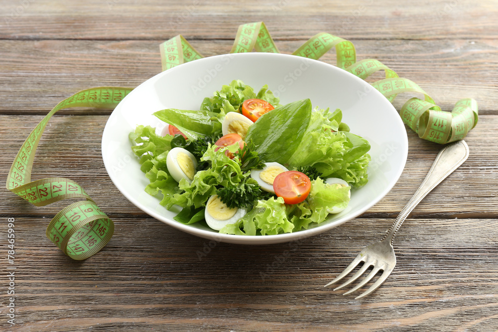 Salad with quail egg and basil in plate Salad with quail egg and basil in plate