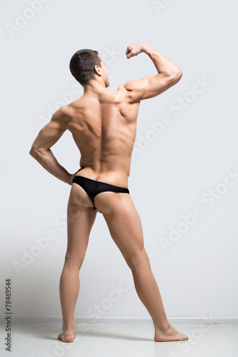 muscular man in a thong